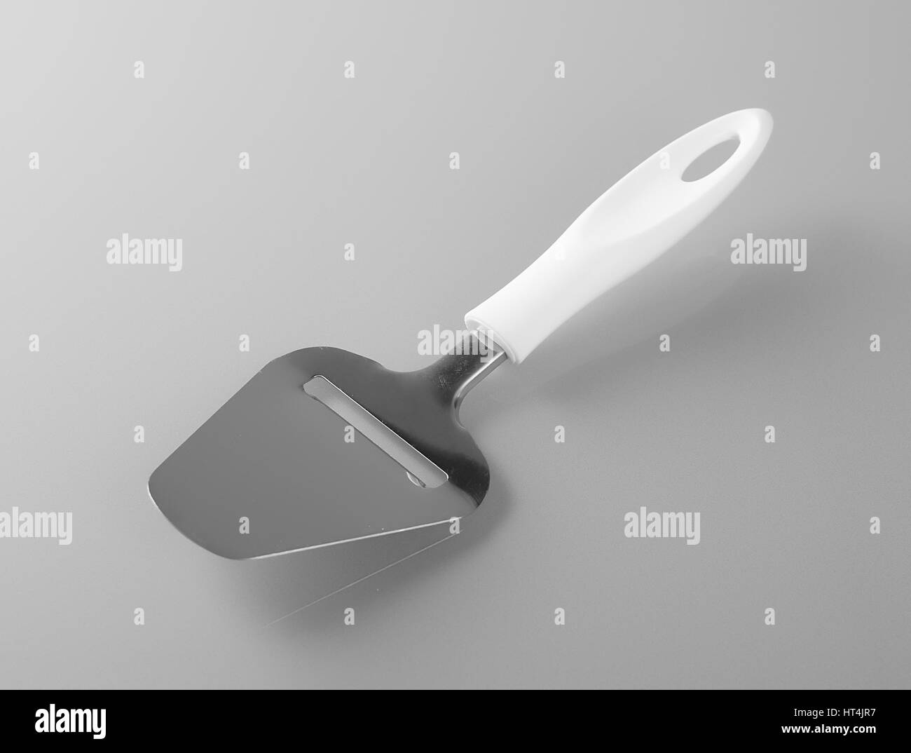 Knife for cutting cheese. Cheese slicer with blade and plastic handle, made of stainless steel Stock Photo