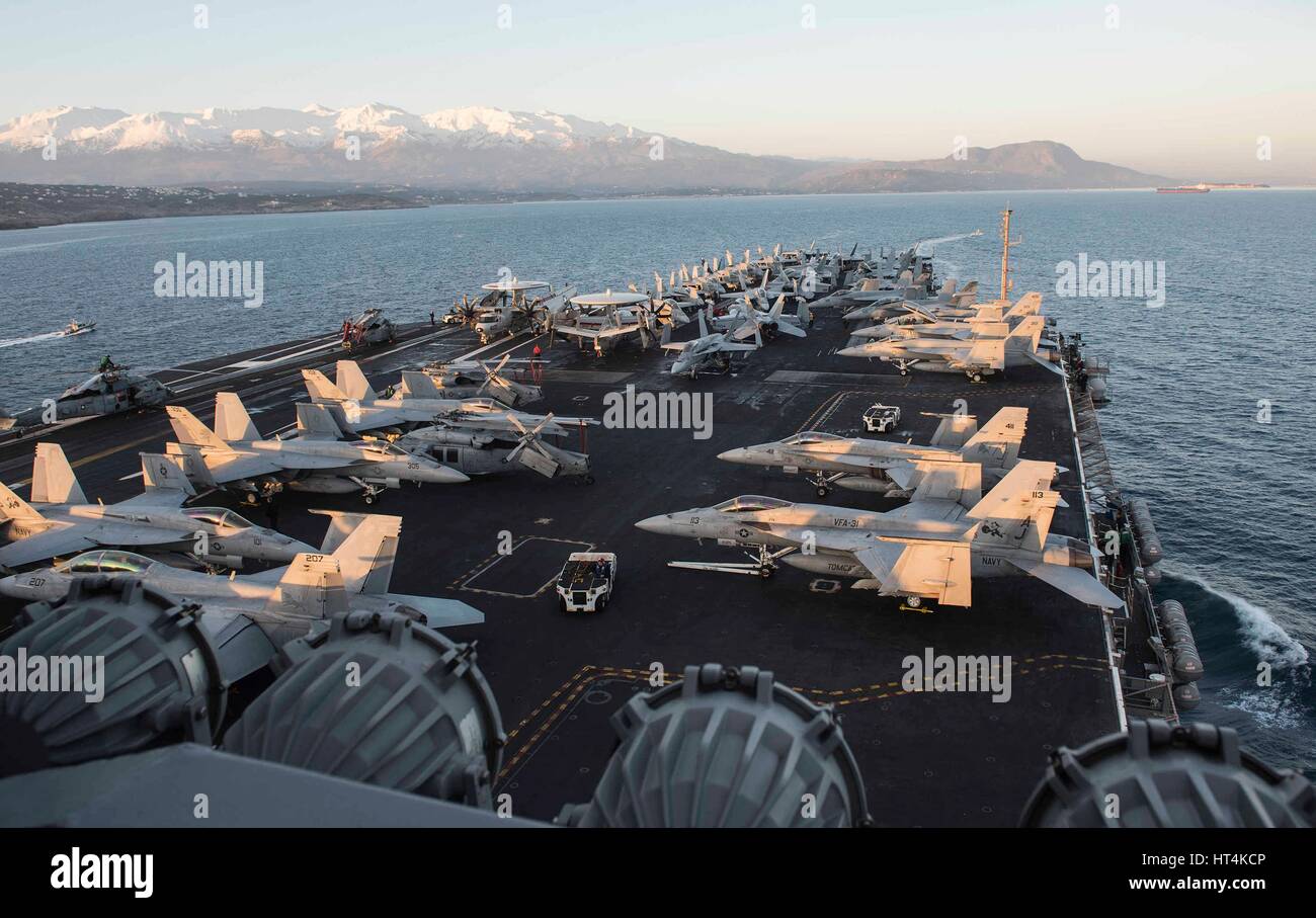 Aircraft sit on the flight deck aboard the USN Nimitz-class aircraft carrier USS George H.W. Bush as it arrives at port February 6, 2017 in Souda Bay, Greece. Stock Photo