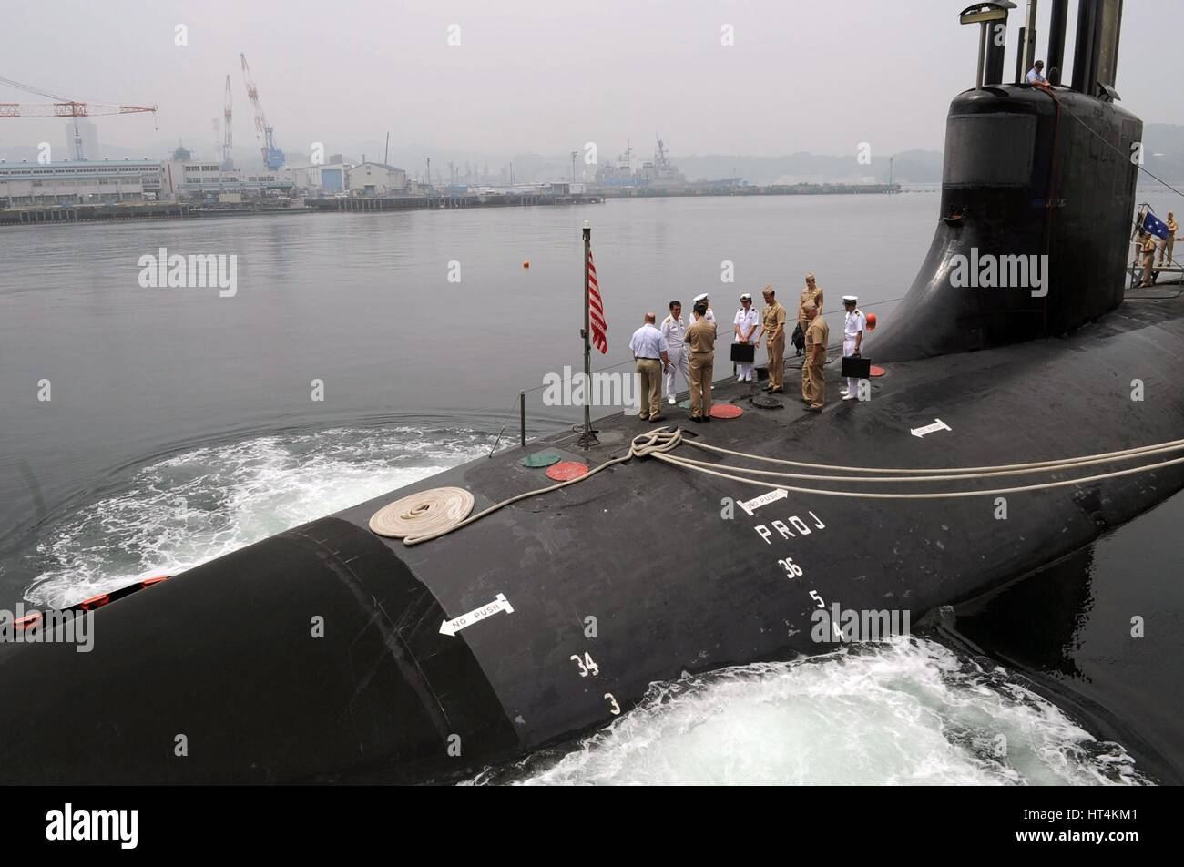 U.S. and Japanese military officials stand on the surface of the USN Seawolf-class submarine USS Seawolf as it demonstrates a low pressure blow to the main ballast May 13, 2009 in Yokosuka, Japan. Stock Photo