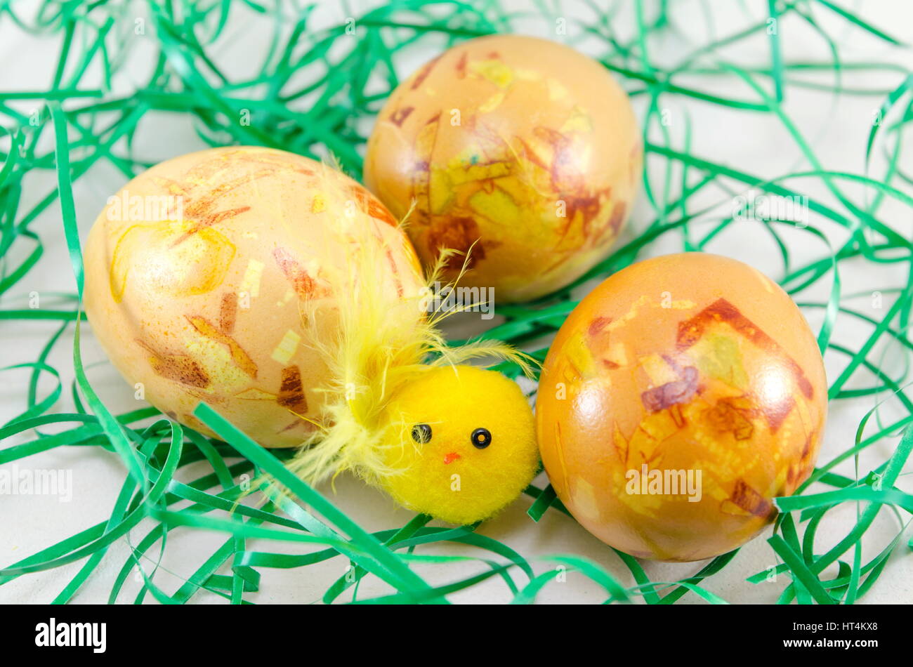 Decorated Easter eggs in green straw on a table Stock Photo
