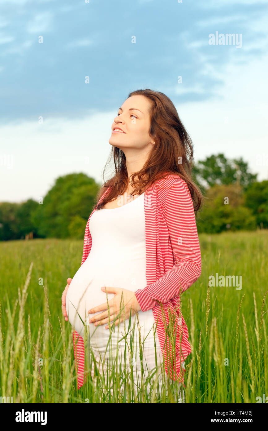 Beautiful pregnant woman in the park Stock Photo - Alamy