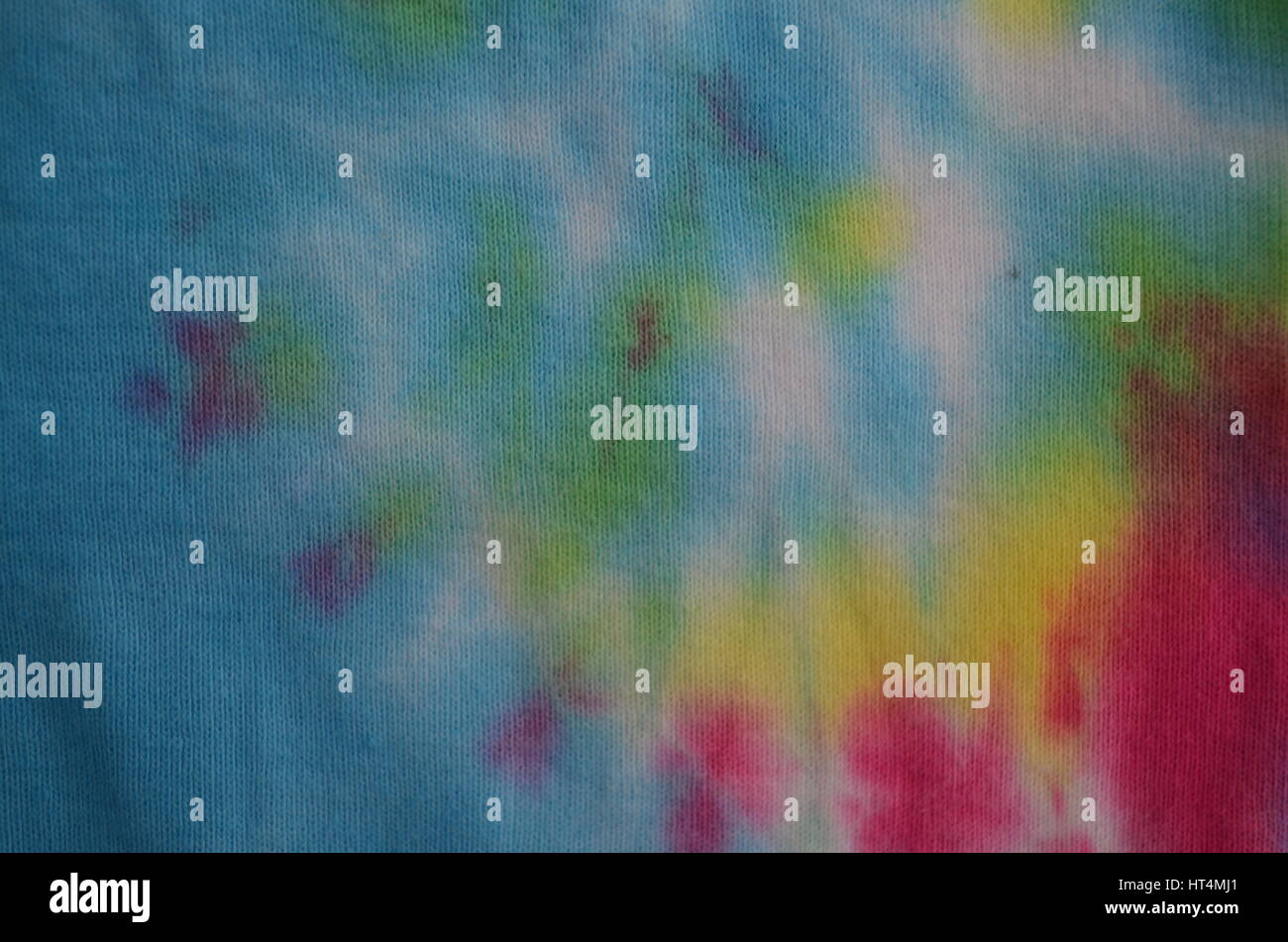 Zoom in on swirl detail of tie-dyed fabric in rainbow colours Stock Photo