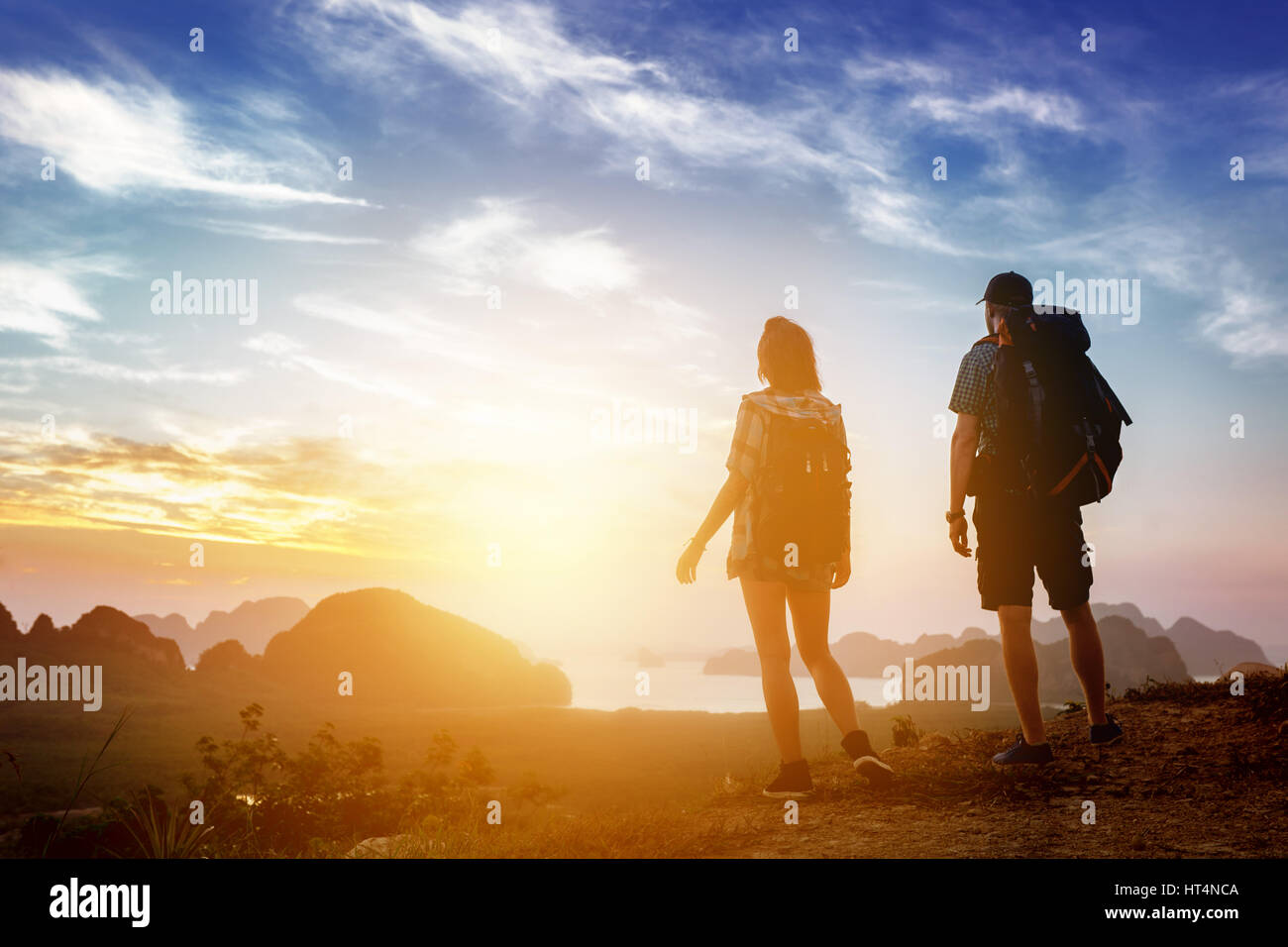 Hikers backpacks mountain top view sunrise Stock Photo