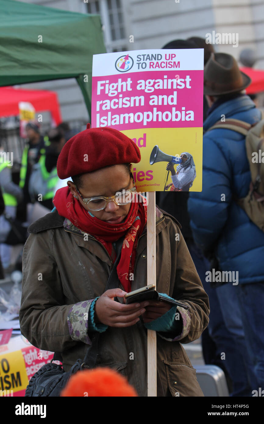LONDON, UK - JANUARY 21: A protestors seen with placards ahead  of the Women's March in London as part of an international campaign on the first full day of Donald Trump's presidency on January 21, 2017. The London march is one of almost 700  sister marches taking place in over sixty countries, organisers aim to highlight women's rights issues, which they perceive to be under threat from the new US administration. © David Mbiyu/Alamy Live News Stock Photo