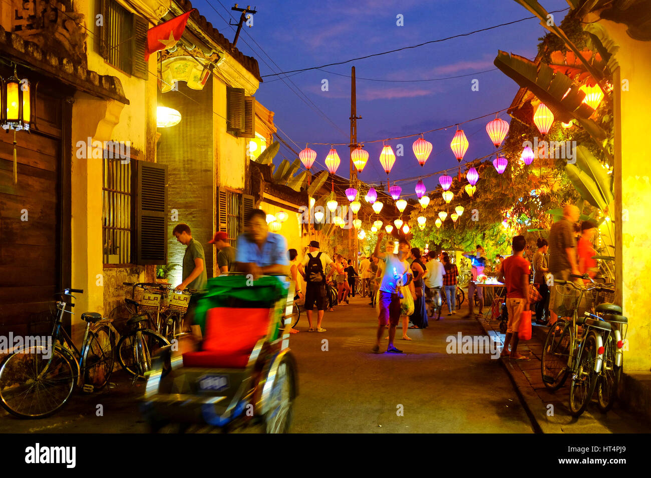 Locals and tourist in Tran Phu street at night, Hoi An, Vietnam Stock Photo