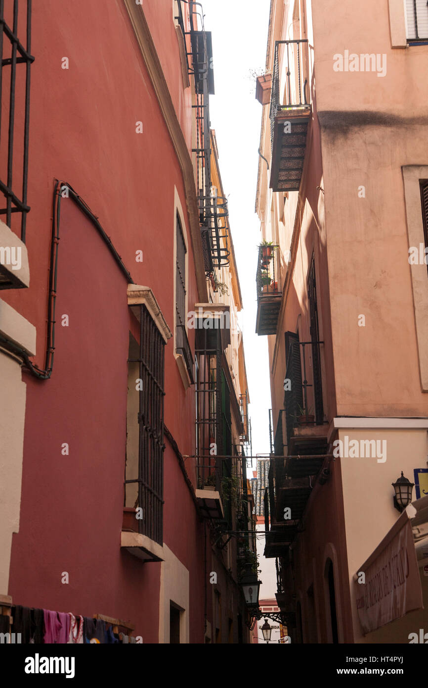 Narrow gap between apartment buildings in city centre of Seville, Spain