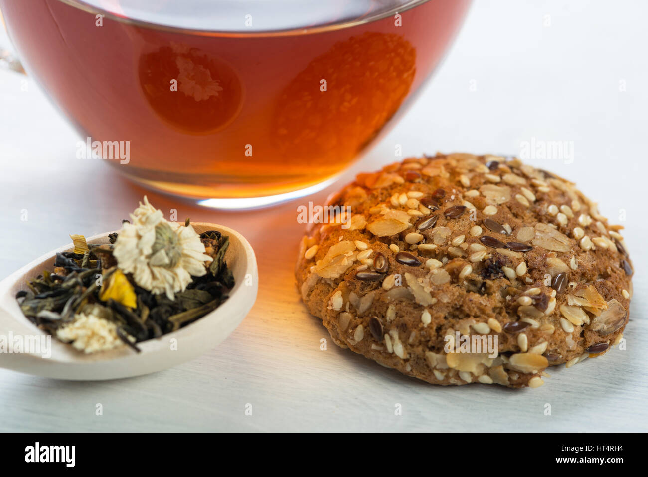 Herbal tea herbs and cookies on table Stock Photo - Alamy