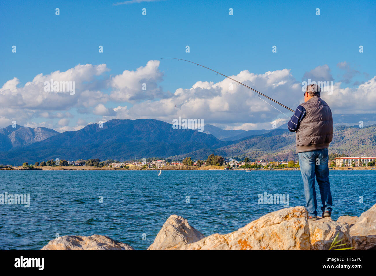amateur rod fish hunter from the shore Stock Photo
