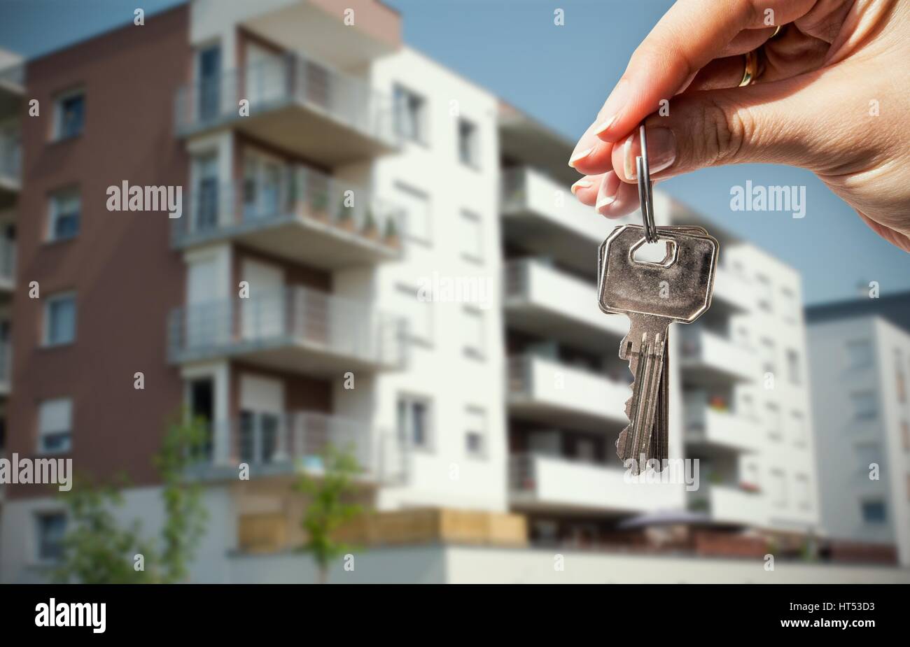 Woman hand holding keys with to new house Stock Photo
