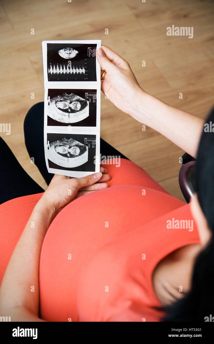 Pregnant woman looking at an ultrasound Stock Photo