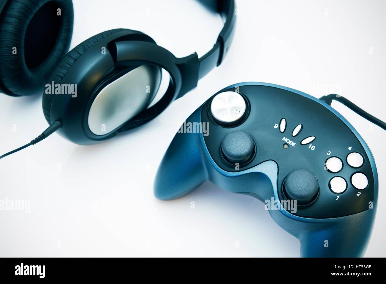 Gamepad and headphones on white background Stock Photo - Alamy