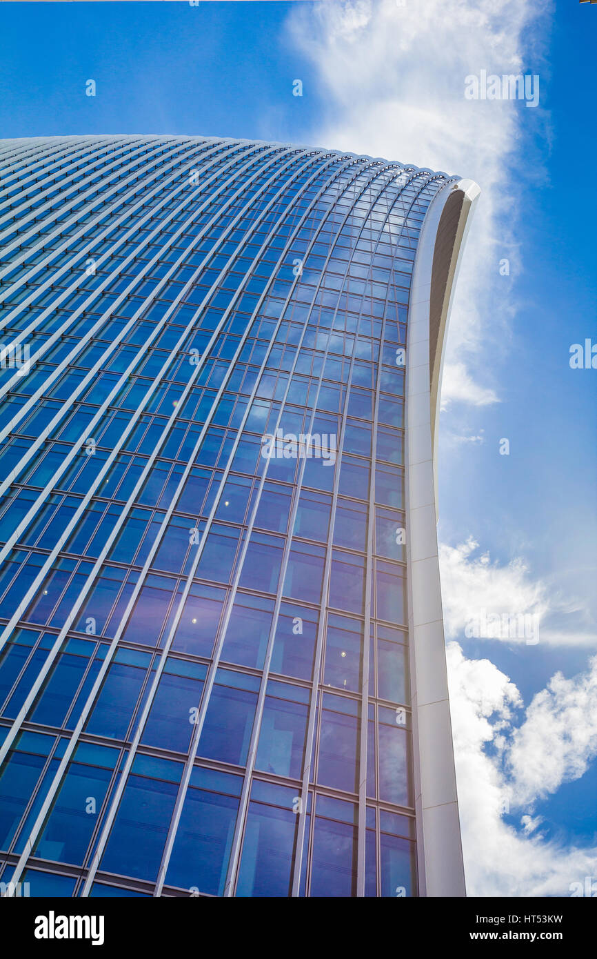 Low view on a skyscraper against the blue sky with curved lines Stock Photo