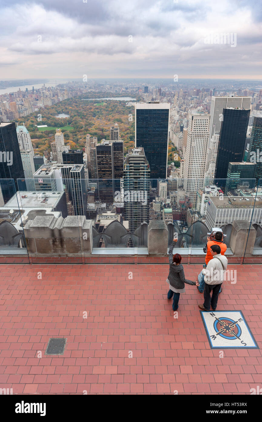 Tourists admire the Central Park view from the Top of The Rock observation deck at Rockefeller Center, New York City, USA. Stock Photo