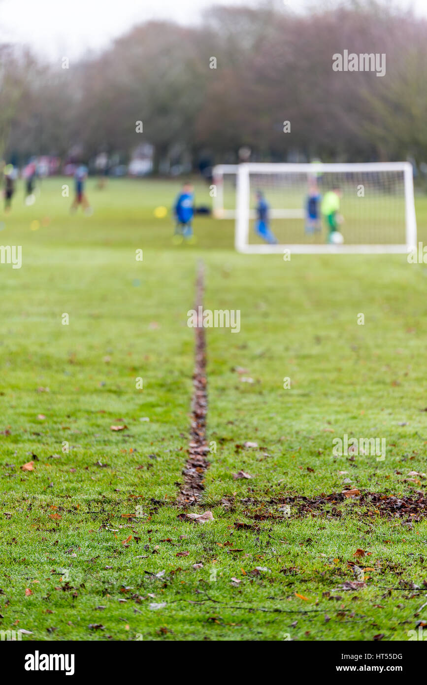 Soccer green field with kids playing on background Stock Photo - Alamy