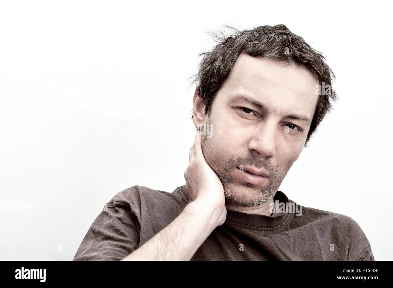 Young man suffering from toothache, teeth pain, swelling face Stock