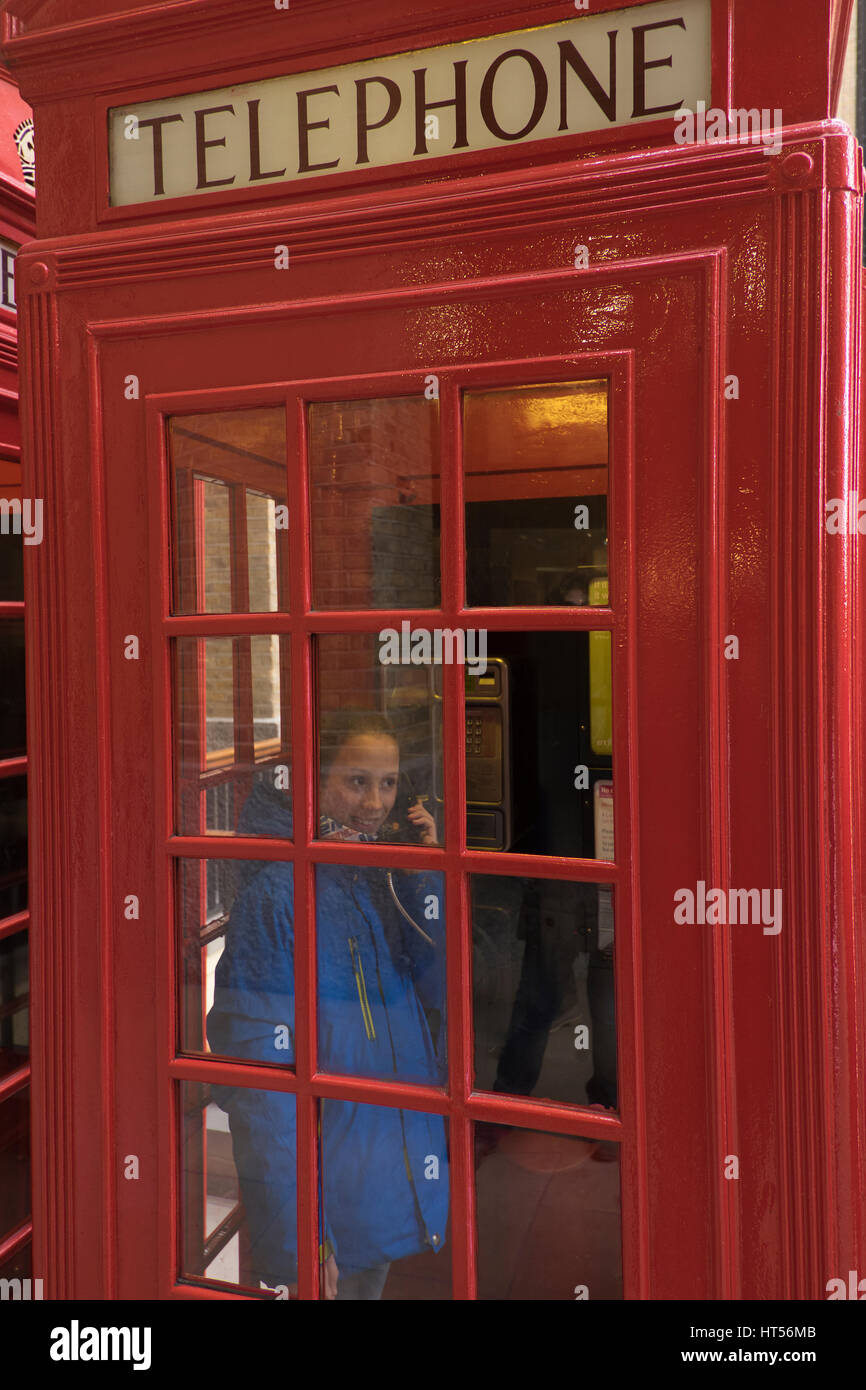 Child in a British Phone box at London Bridge in London England Stock Photo