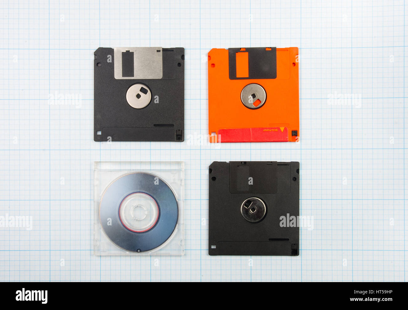 vintage background - computer floppy disks and mini-CD on the blueprint paper, toned Stock Photo