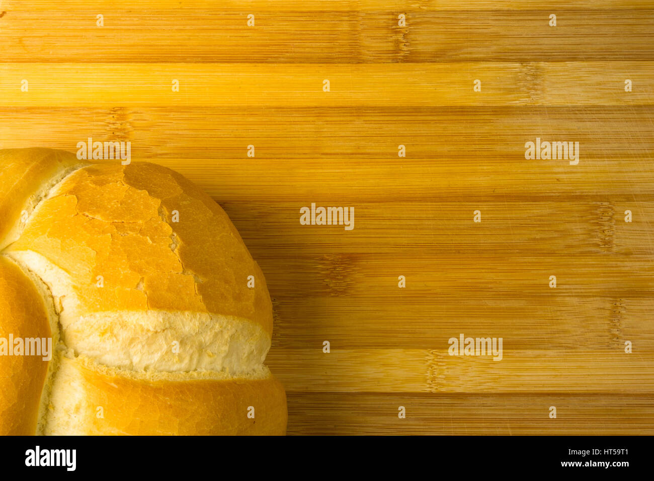fresh braided loaf of white wheat bread on bamboo wooden background Stock Photo