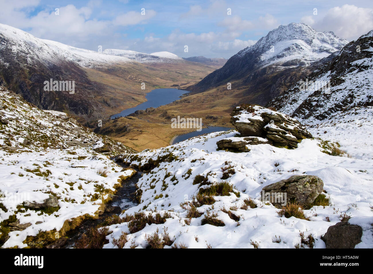 High view to Ogwen Valley and Mount Tryfan from Cwm Clyd on Y Garn with snow in Snowdonia National Park mountains. Ogwen, Gwynedd, North Wales, UK Stock Photo