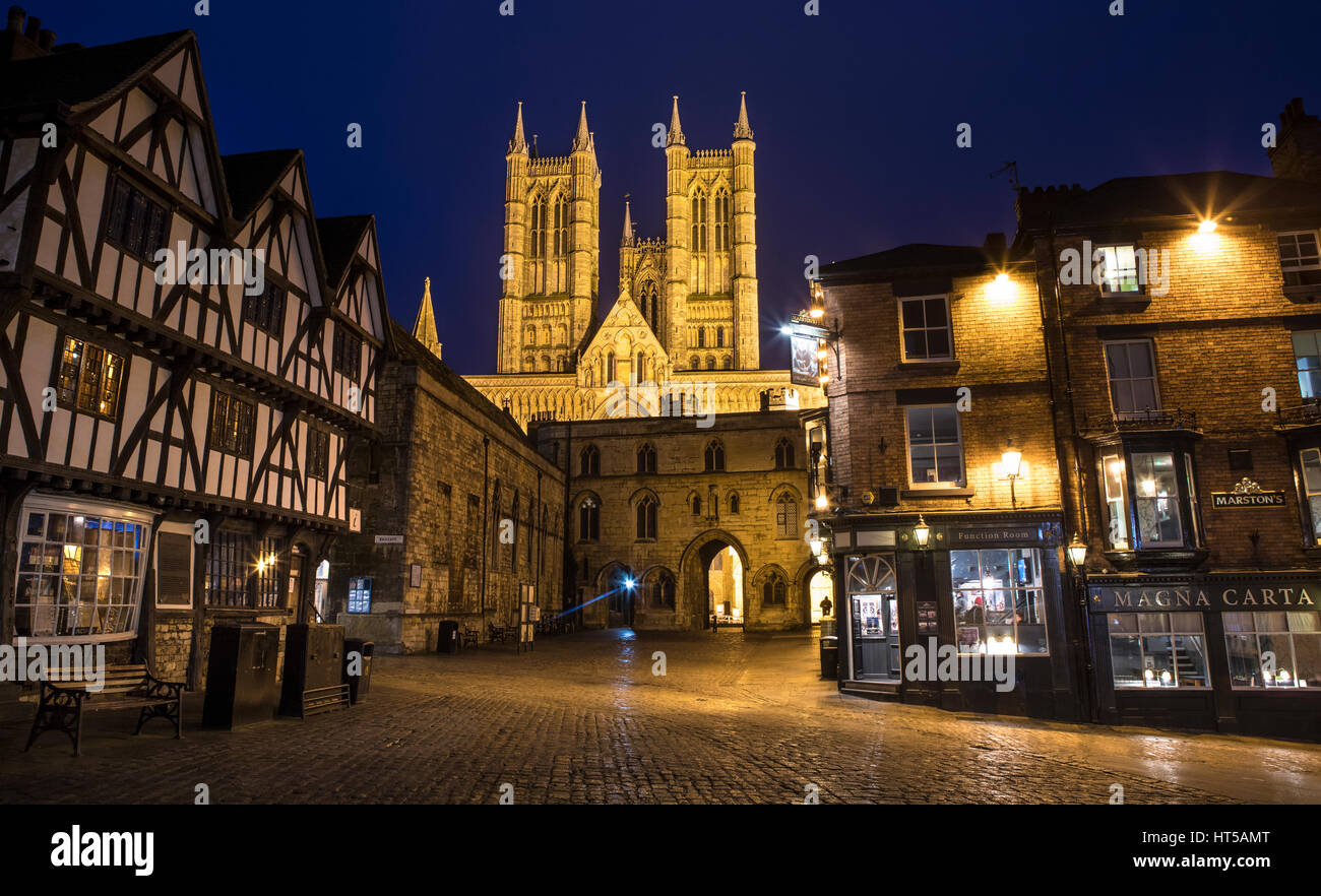 A dusk-time view of Lincoln Cathedral viewed from Castle Hill.  The view takes in the sights of Exchequer Gate, the Magna Carta public house and the T Stock Photo