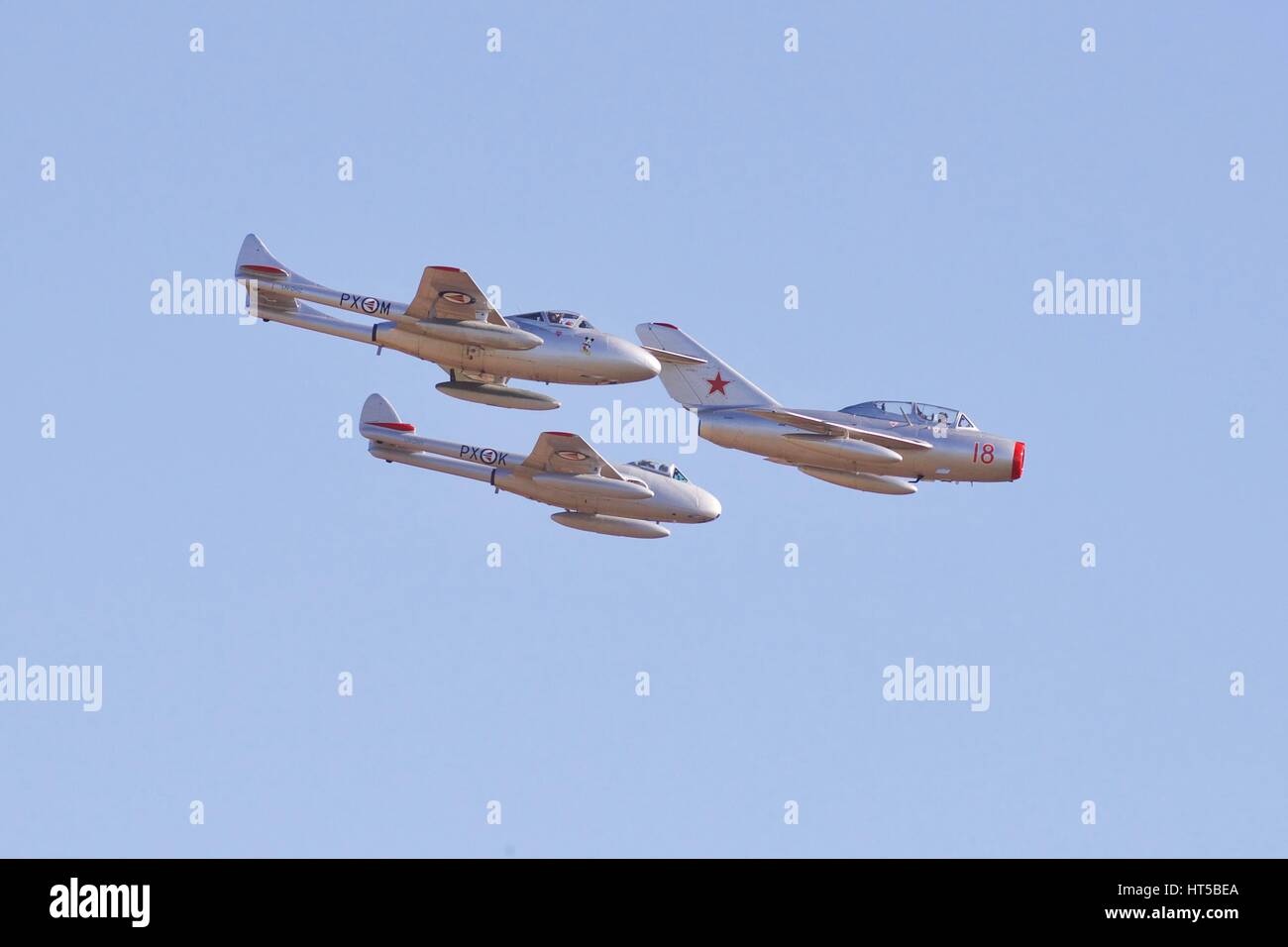 Mikoyan-Gurevich MiG-15, flying in formation with two De Havilland Vampire fighter jets Stock Photo