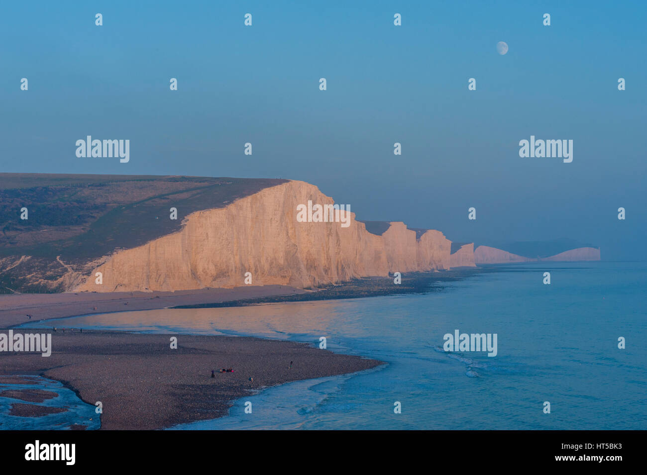 Moon rise over the severn sisters and Beachy head from Seaford head Sussex Stock Photo