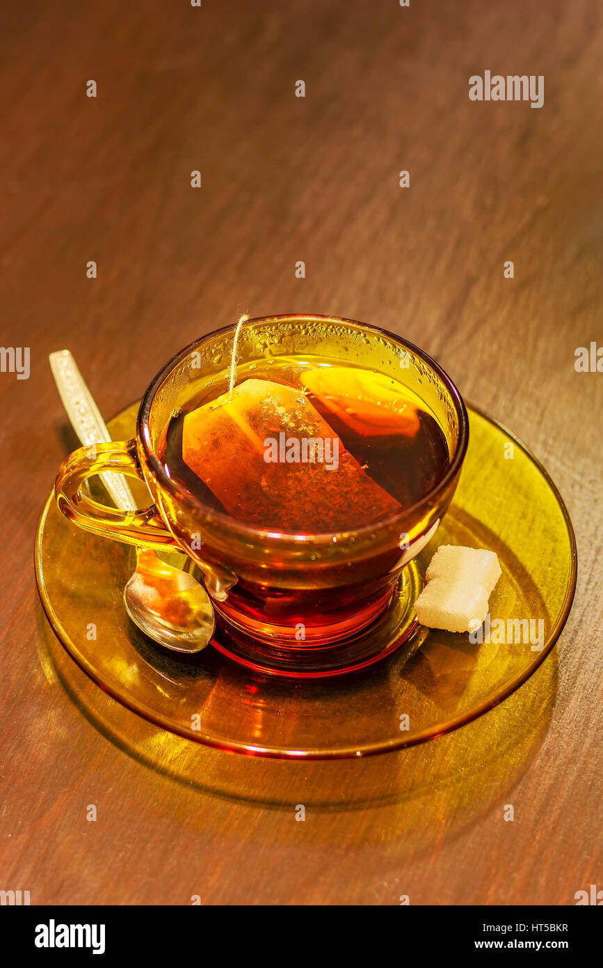 Hot tea cup with tea bag,spoon and sugar on table Stock Photo Alamy