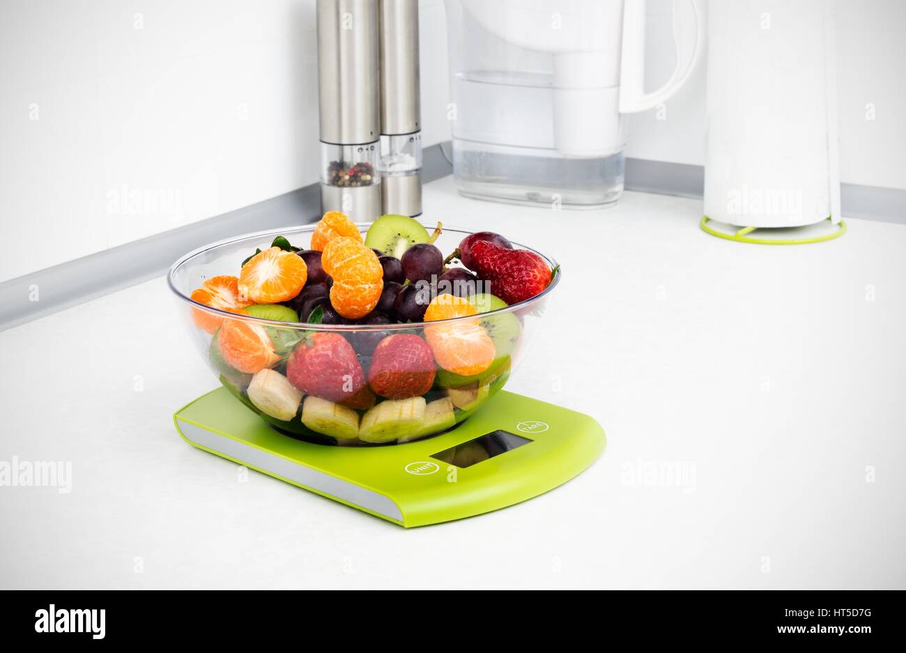 Lots of fruit on the kitchen scale in a modern kitchen Stock Photo