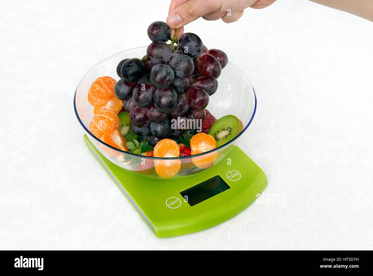 Lots of fruit on the kitchen scale in a modern kitchen Stock Photo