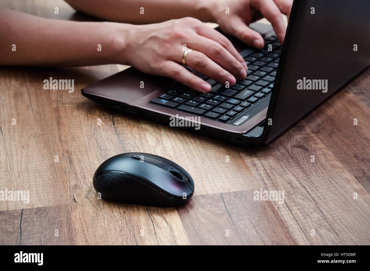 Man working with laptop on wooden background Stock Photo