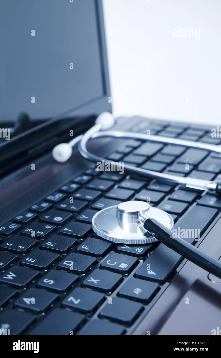 Diagnosis and repair of computers. Stethoscope on laptop Stock Photo