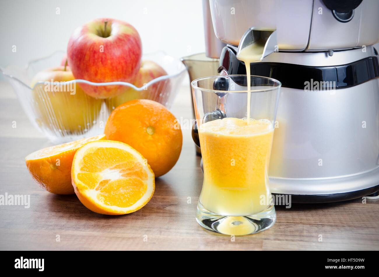 Juicer and orange juice. Fruits in background Stock Photo Alamy