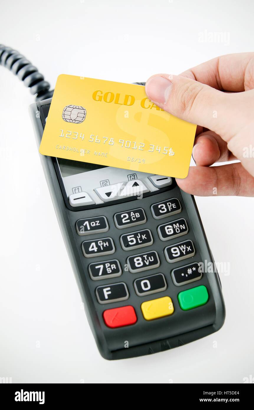 Contactless gold payment card with NFC chip using with terminal device Stock Photo