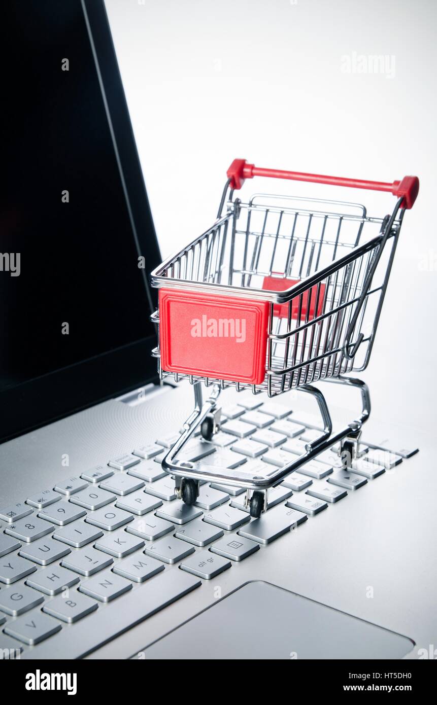 Internet shopping concept. Basket on laptop keyboard Stock Photo