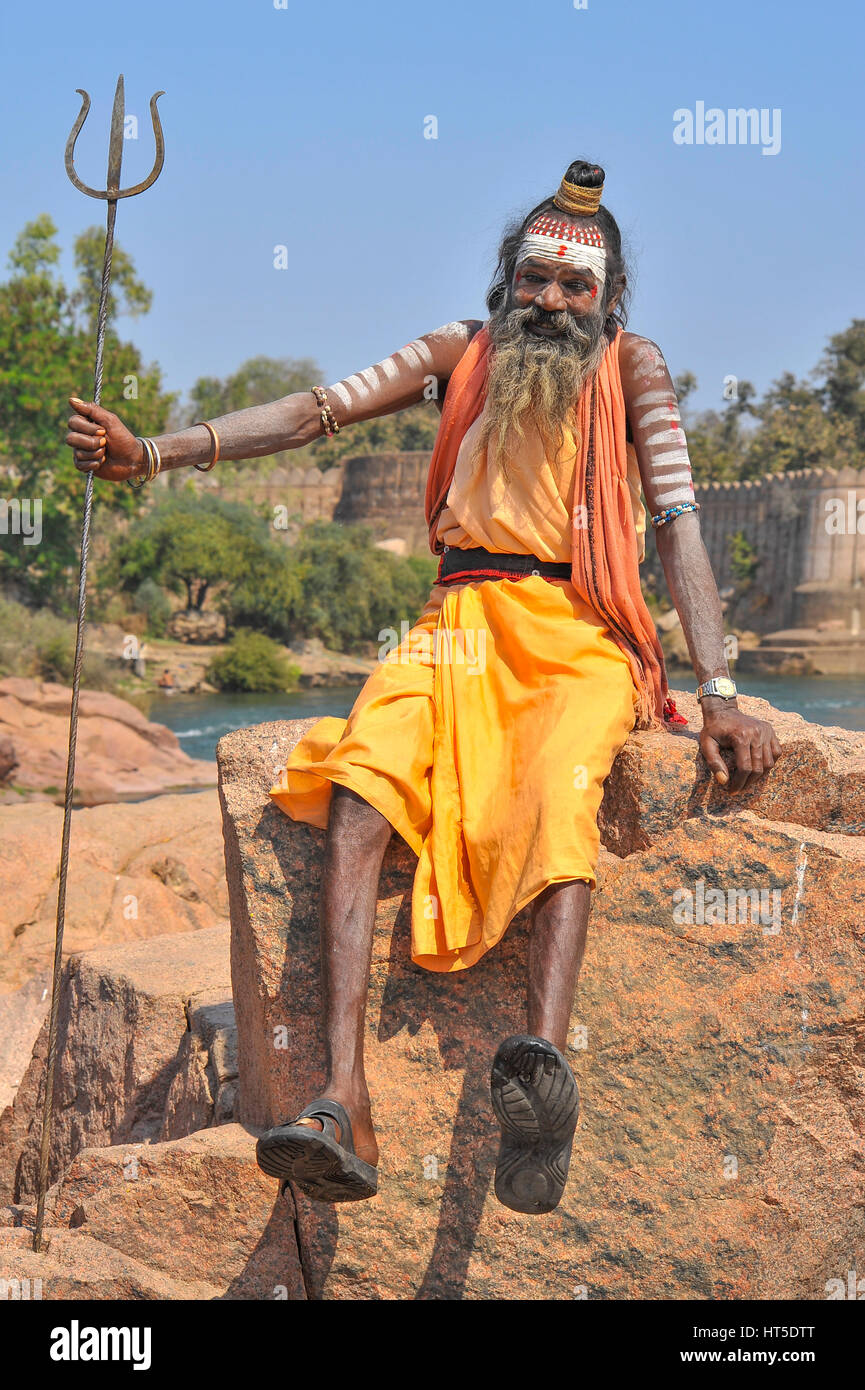 Ascetic Shaivite poses holding a trident, India Stock Photo