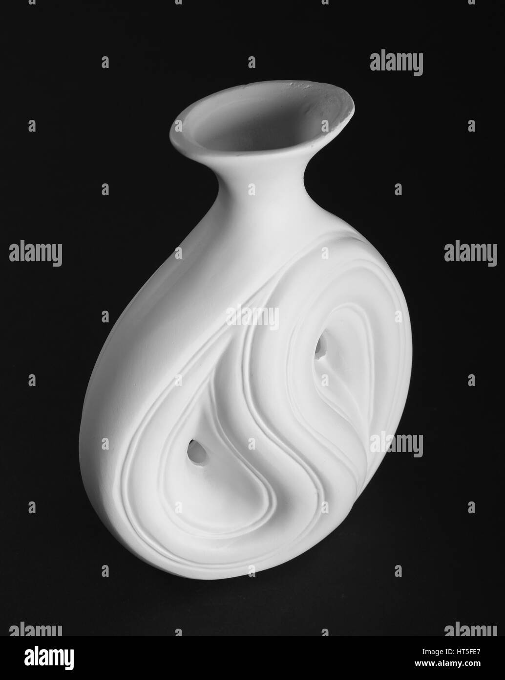 Beautiful antique white porcelain vase on black background Stock Photo