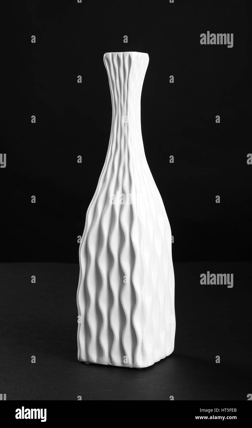 Beautiful antique white porcelain vase on black background Stock Photo