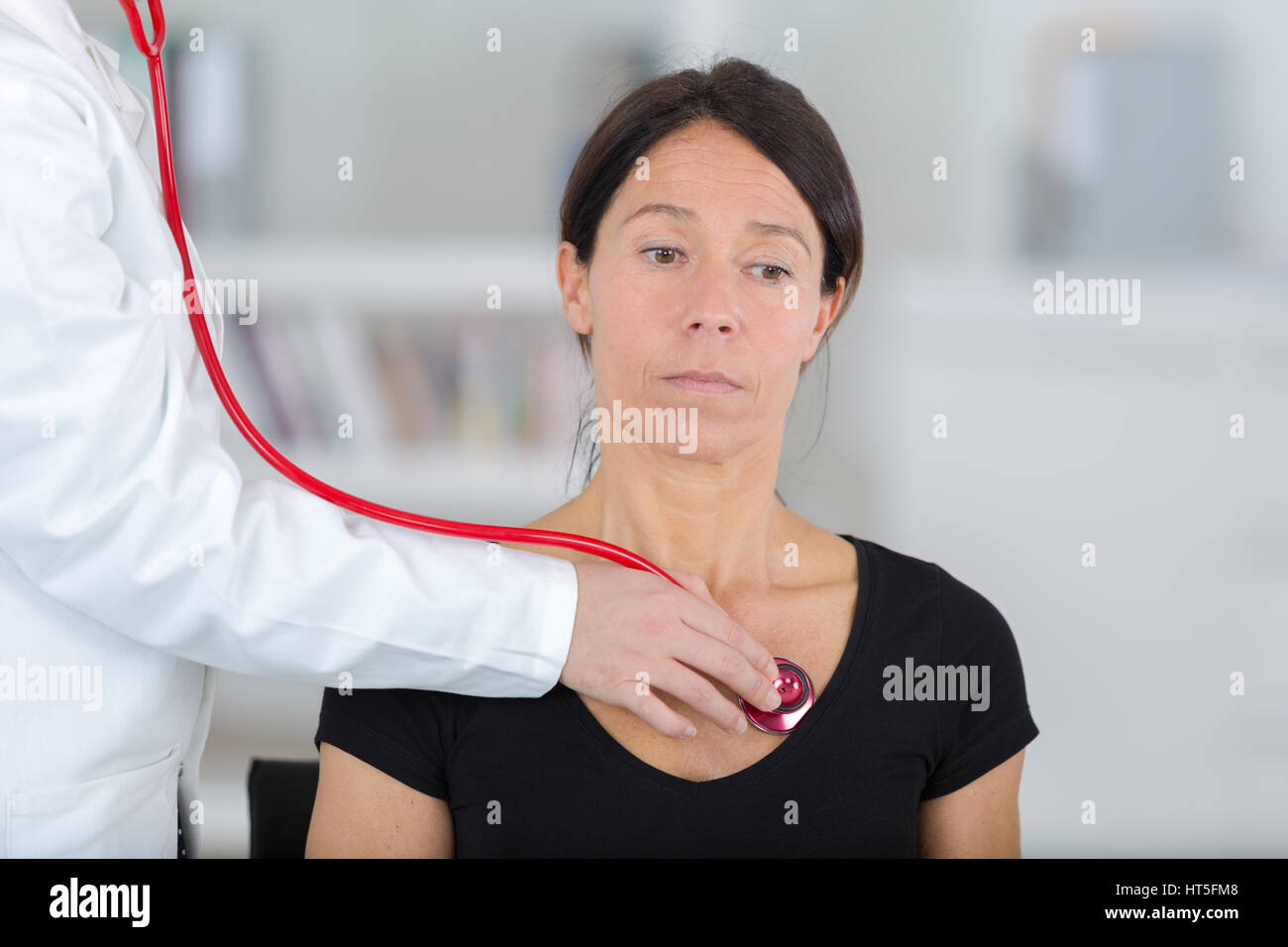 female doctor examining the patient with stethoscope Stock Photo - Alamy