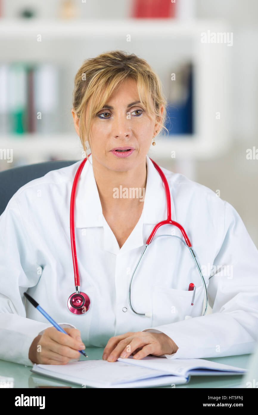Female doctor writing in notebook hi-res stock photography and images ...