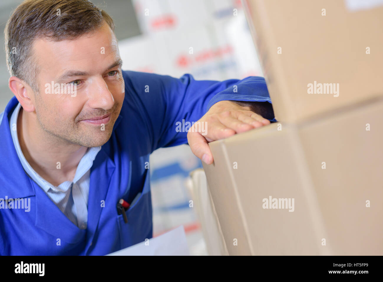 Man looking at boxes Stock Photo Alamy