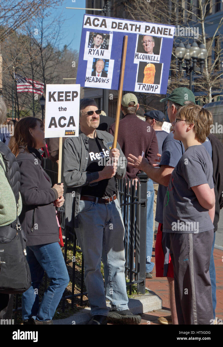 Asheville, North Carolina, USA - February 25, 2017:  Demonstrators at an Affordable Care Act (ACA) rally hold signs saying 'Keep the ACA' and 'ACA Dea Stock Photo