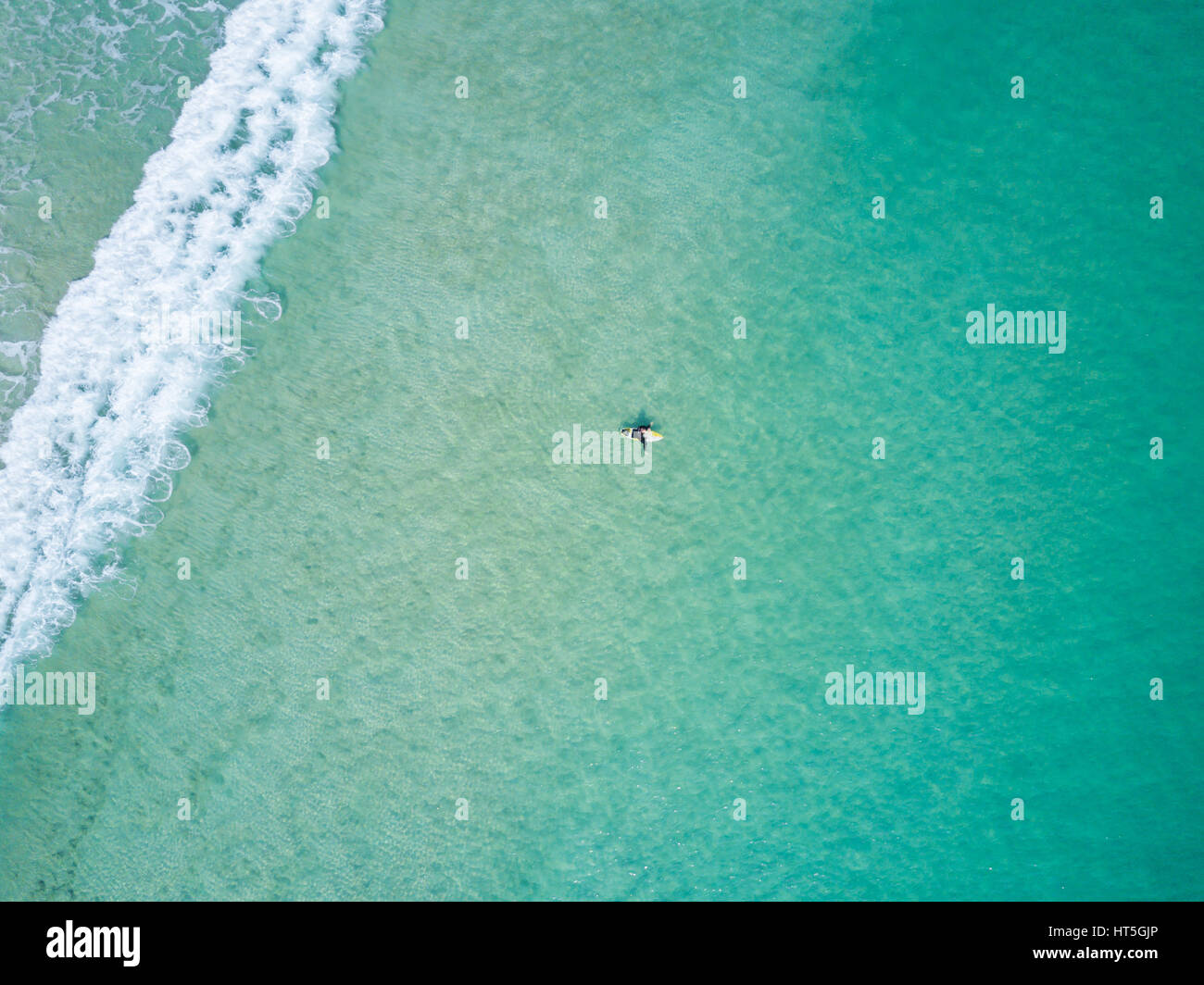 Aerial view of a surfer in Sai Kung, Hong Kong. Sai Kung is well known for its clear water, beach and hiking trails. Stock Photo