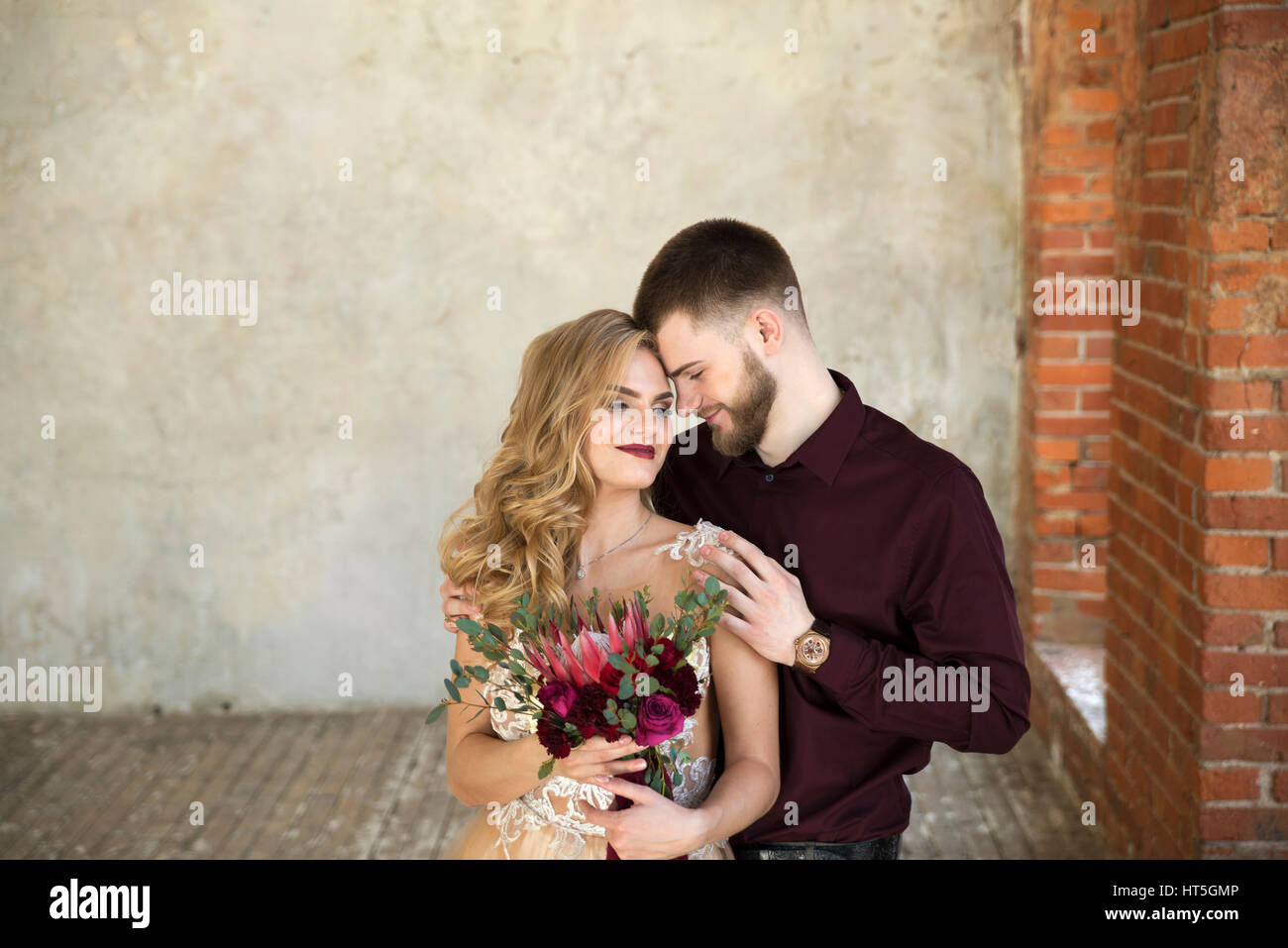 Bride and groom pose at wedding ceremony Stock Photo