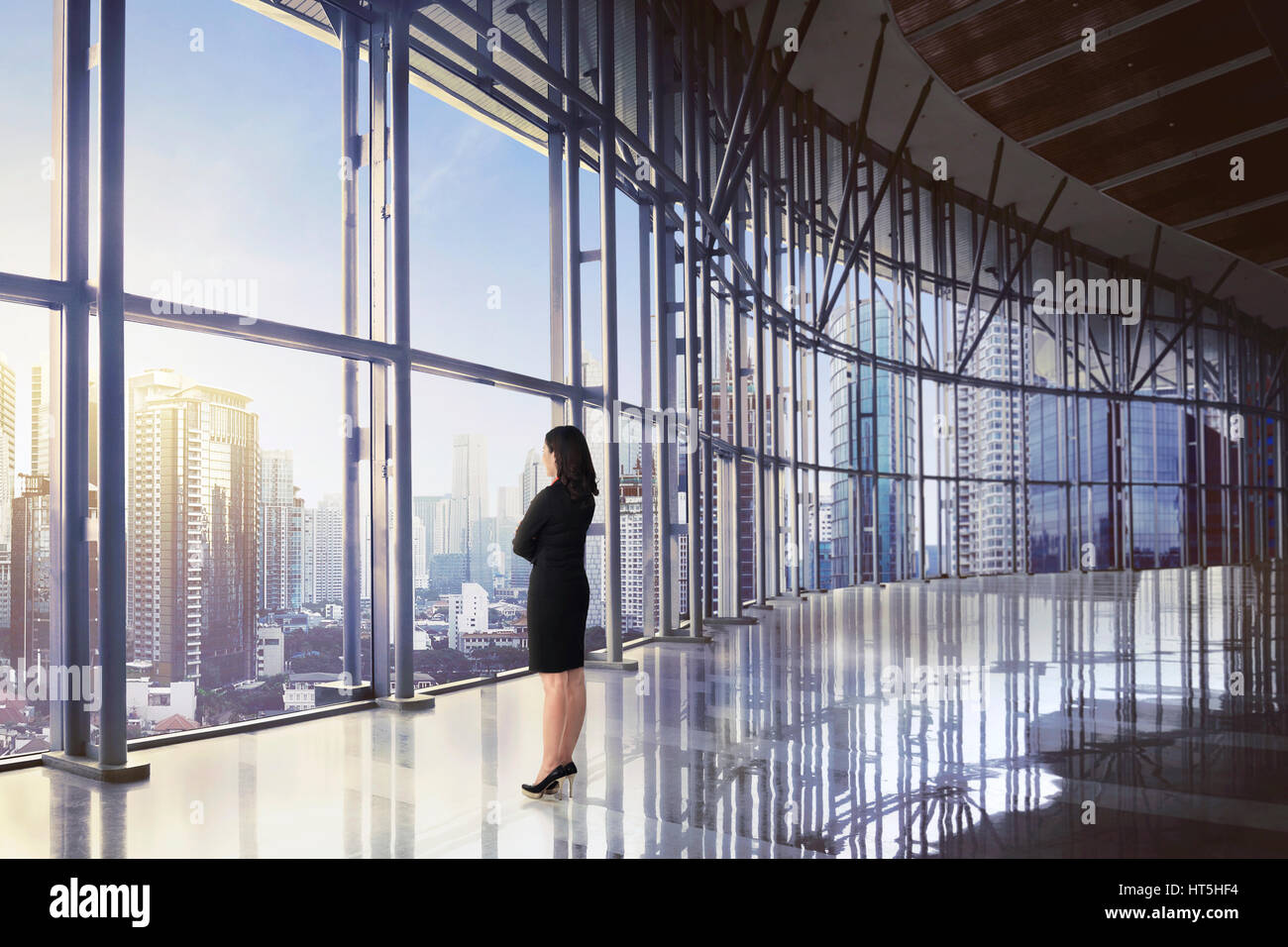Back view of asian business woman relaxing while looking skyscraper at ...