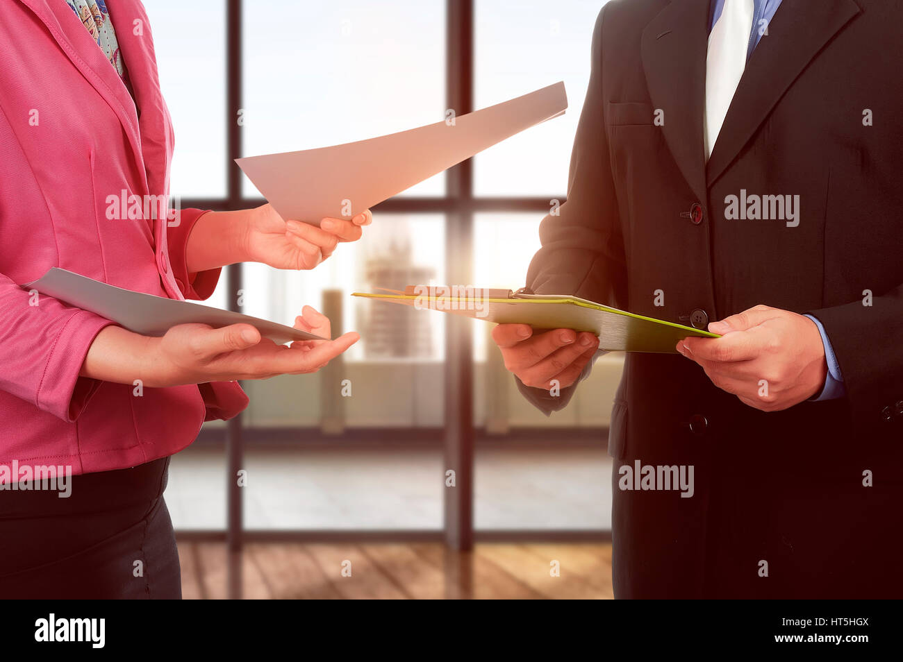 Business man and woman hand holding clipboard and paper over office background Stock Photo