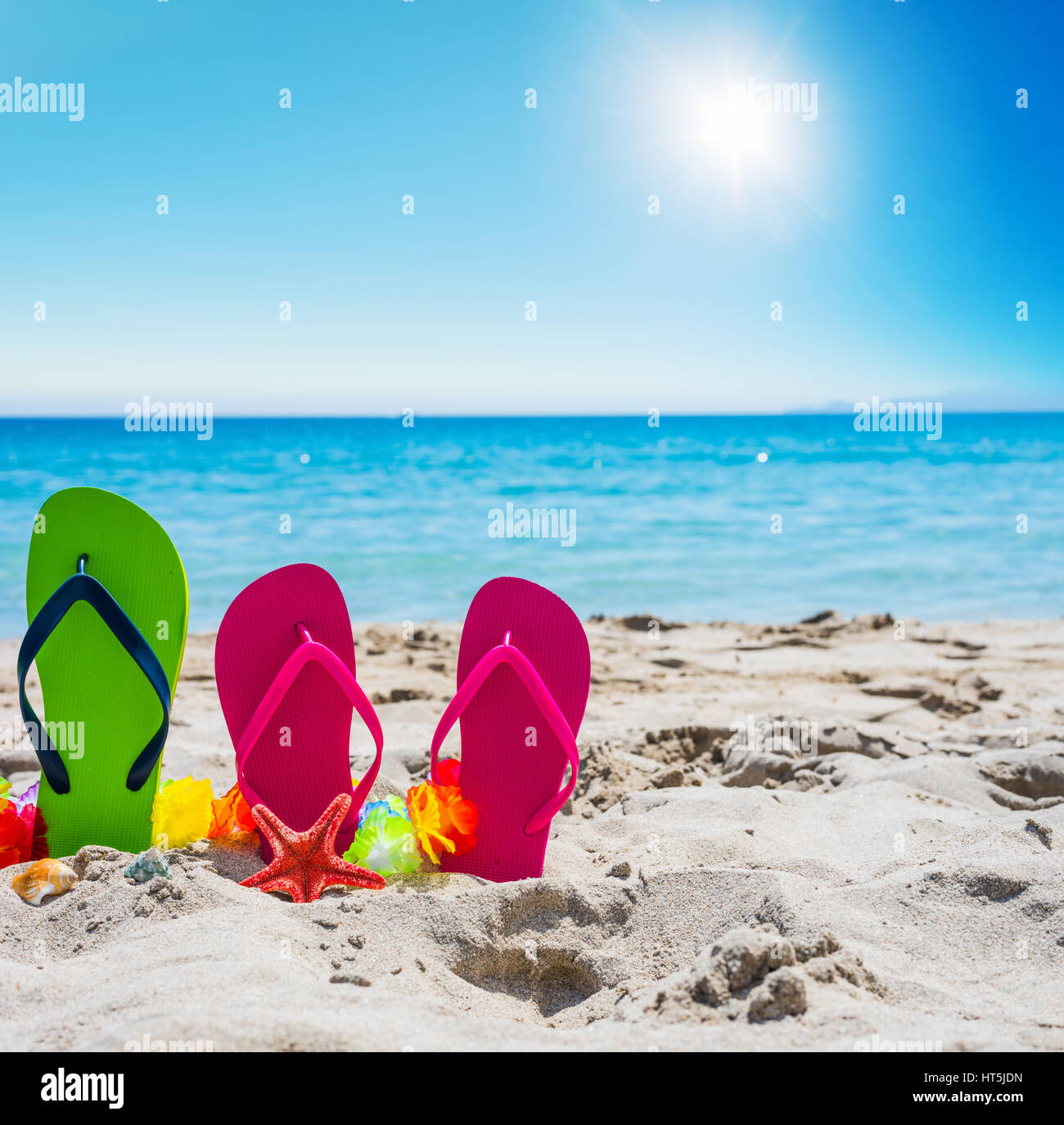 Flip flops on the sand in the summertime Stock Photo - Alamy