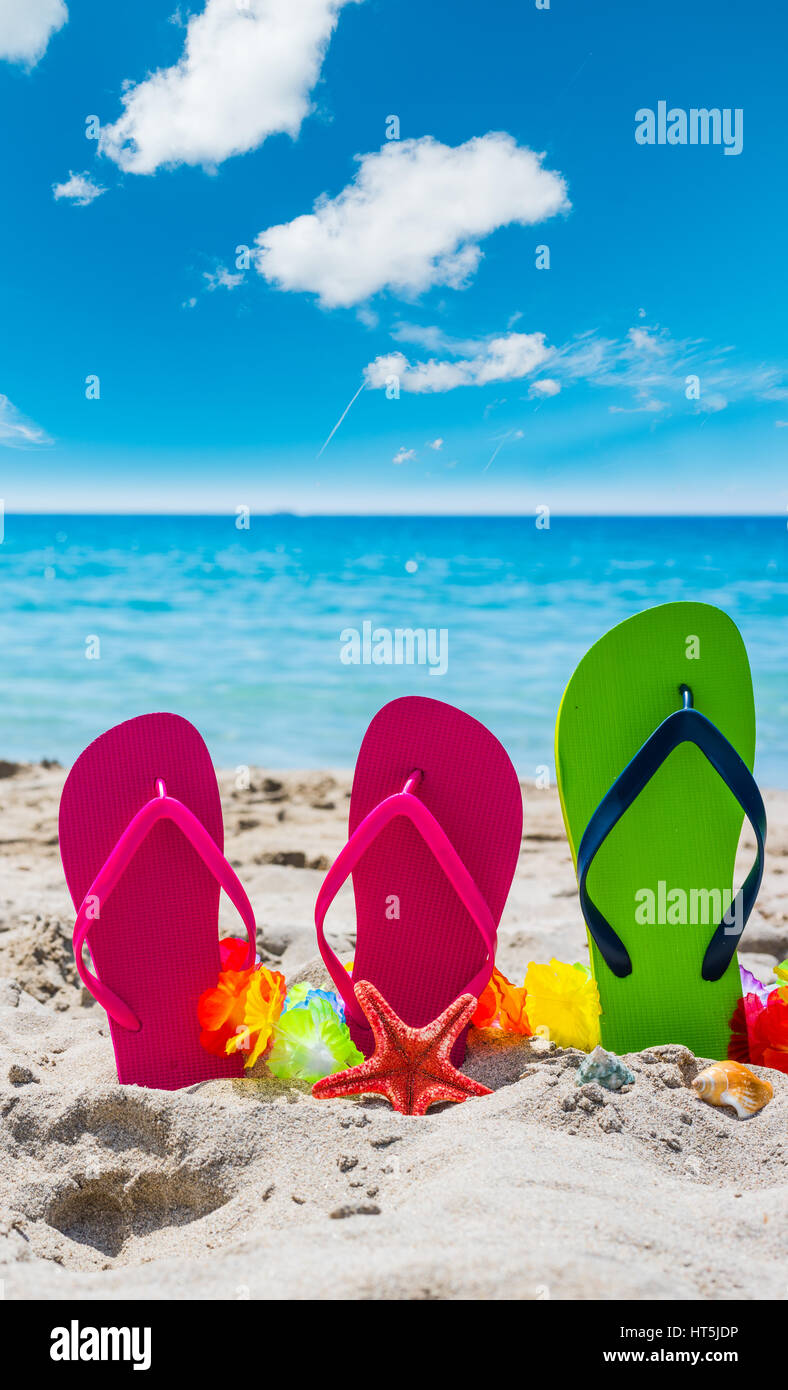 Flip flops on the sand in the summertime Stock Photo - Alamy