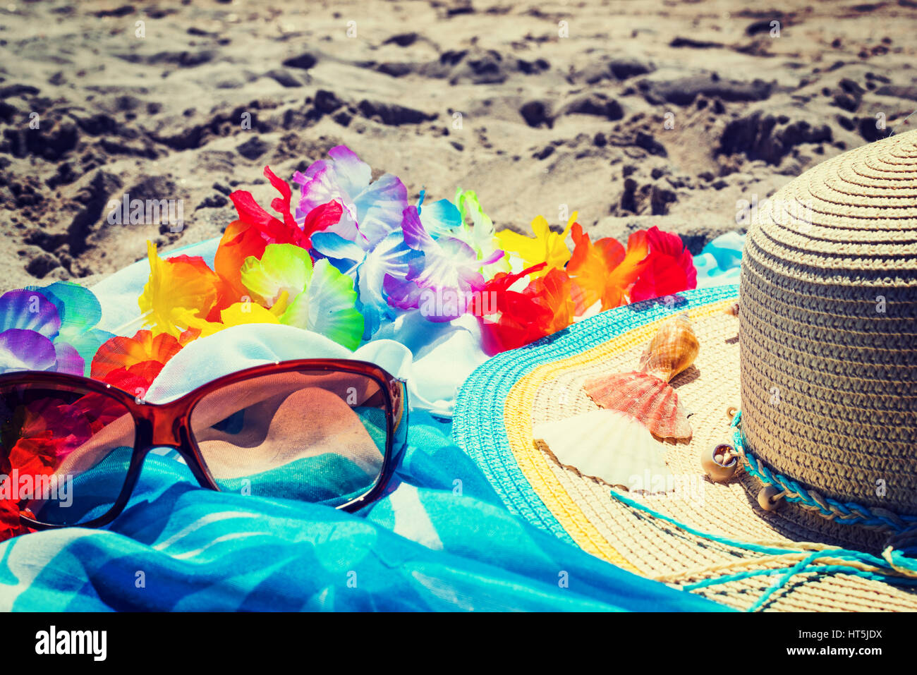 sunglasses and straw hat on the sand Stock Photo - Alamy