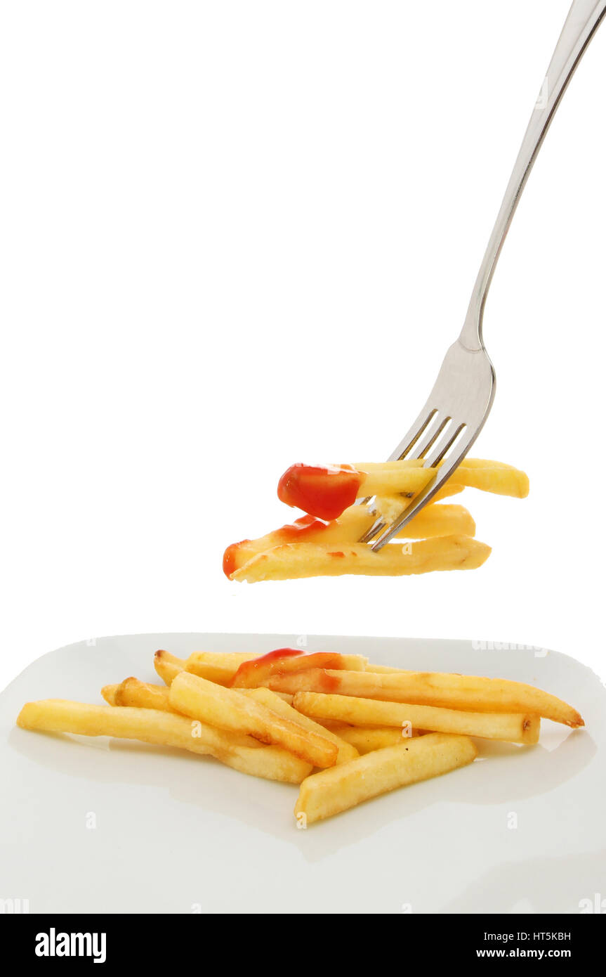 French fries with ketchup on a plate and a fork against a white background Stock Photo
