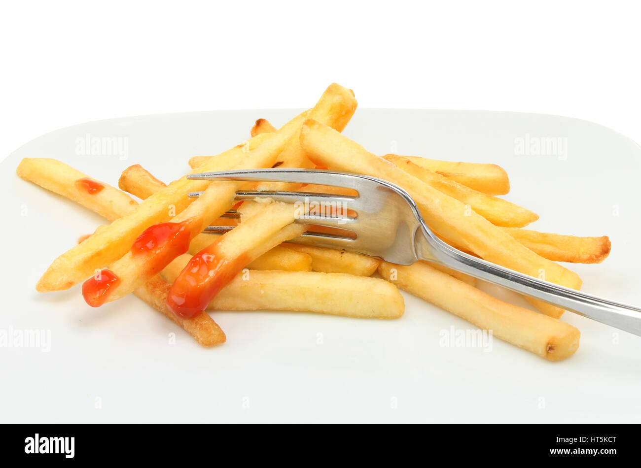 French fries with ketchup and a fork on a plate Stock Photo